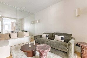 Ein modernes Wohnzimmer mit einer Couch, einem Couchtisch und einem Beistelltisch.