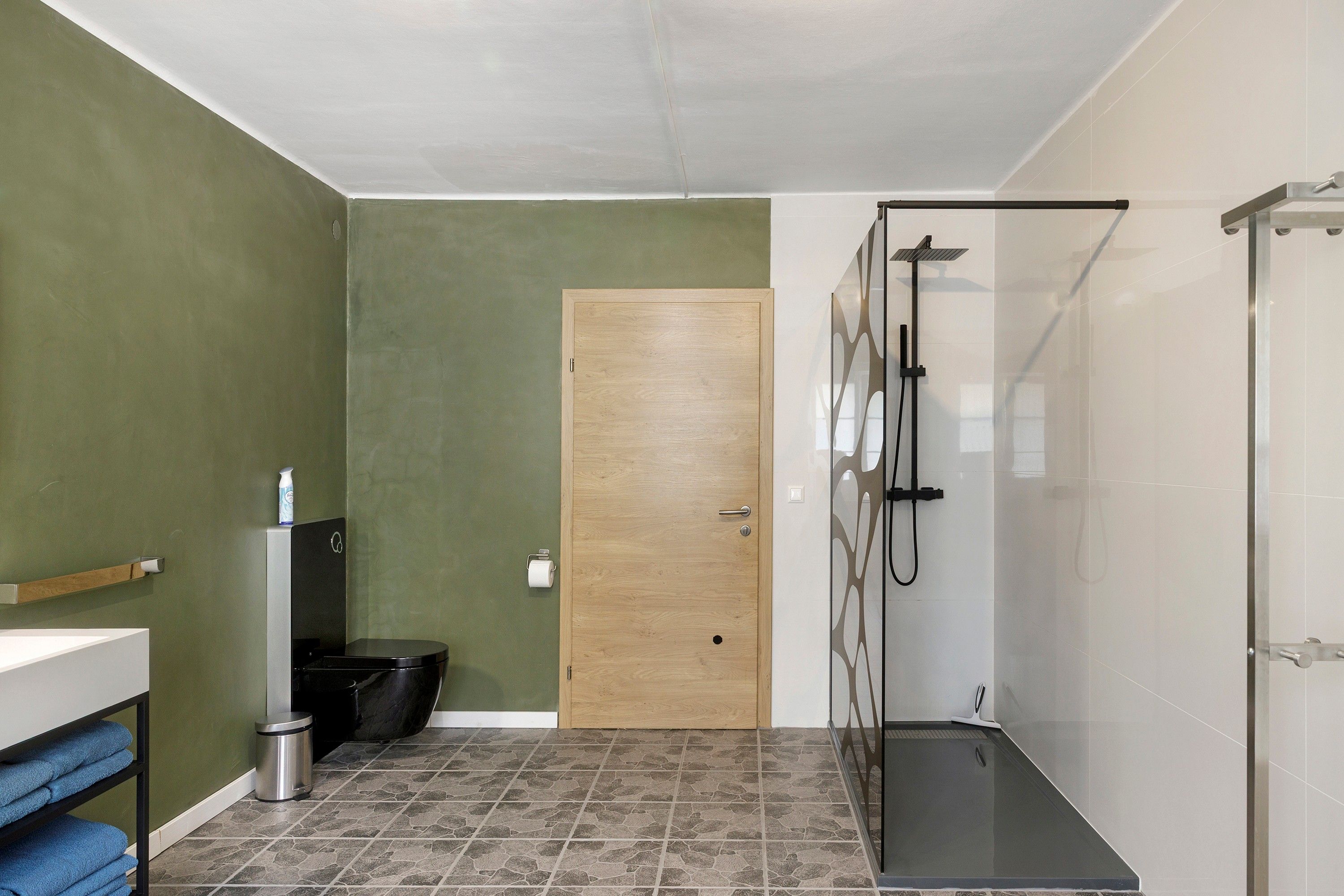 A bathroom with a shower, toilet, and sink.