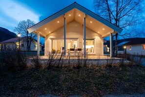 A house with a covered porch, a visible kitchen area, and a garage.