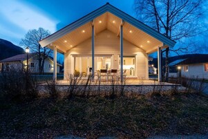 A house with a covered porch, a visible kitchen area, and a garage.