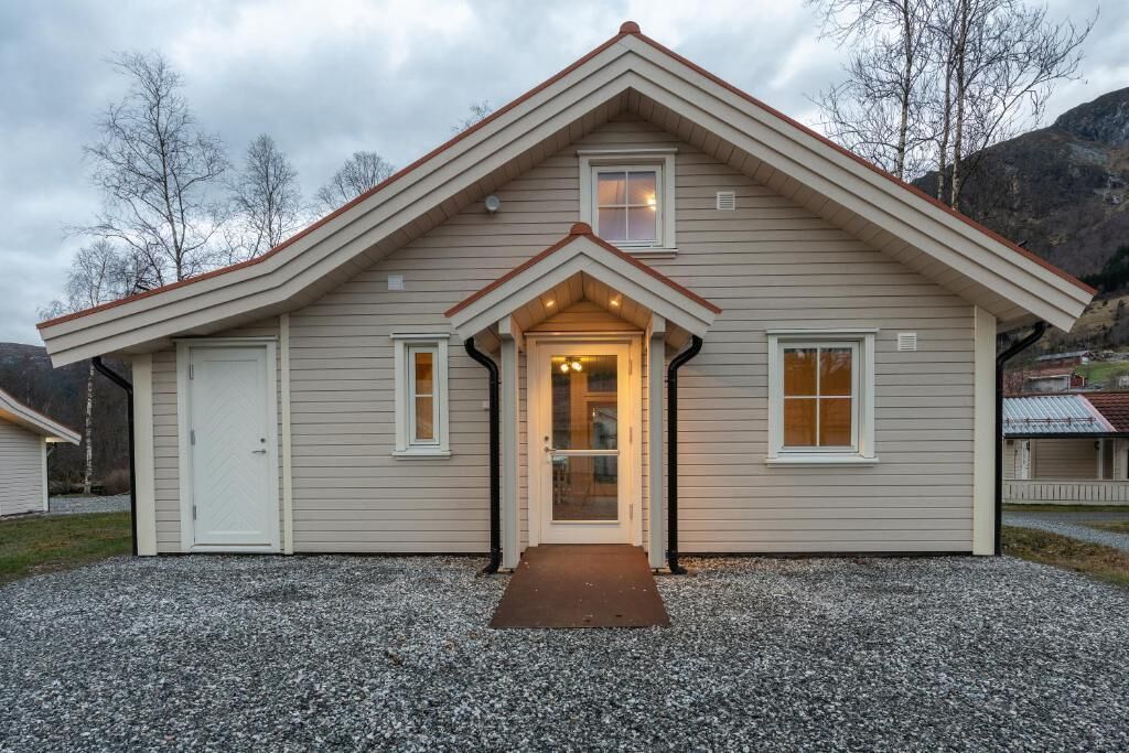 A single-story house with a gabled roof, a front door, and a small porch.