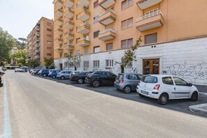 A row of parked cars along a street with a row of multi-story buildings in the background. - Vatican Flat—2 Bedrooms, 2 En-suite Bathrooms, and a Balcony (Rome)