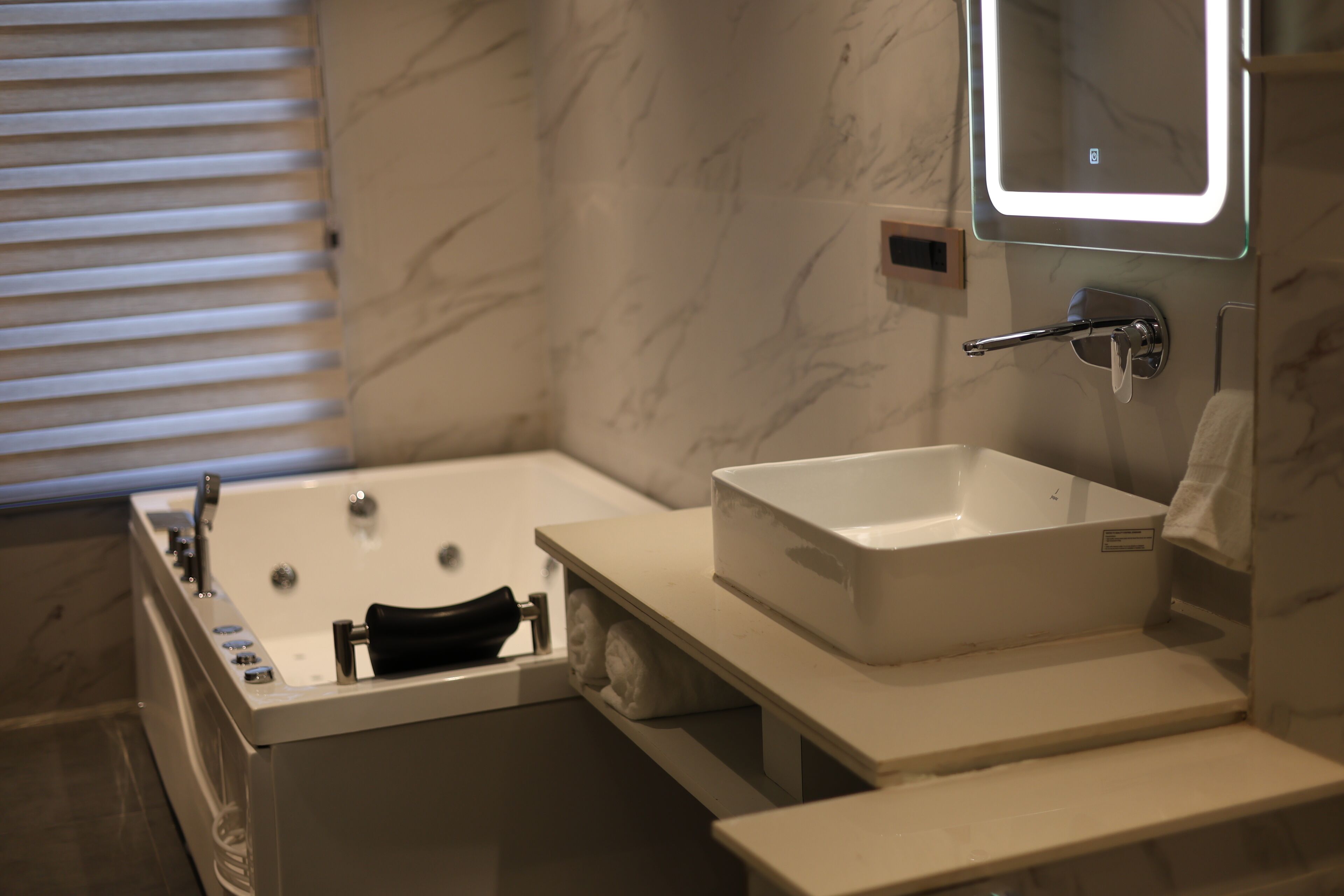 Un baño moderno con bañera, lavabo y espejo.