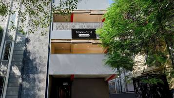 A modern building with a sign reading 'TOWNHOUSE Company Serviced.'