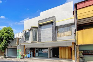 A multi-story building with a storefront, large windows, and a visible entrance. - Luxury Deluxe DBL Retreat W/ Free Wifi and Parking (Yogyakarta)