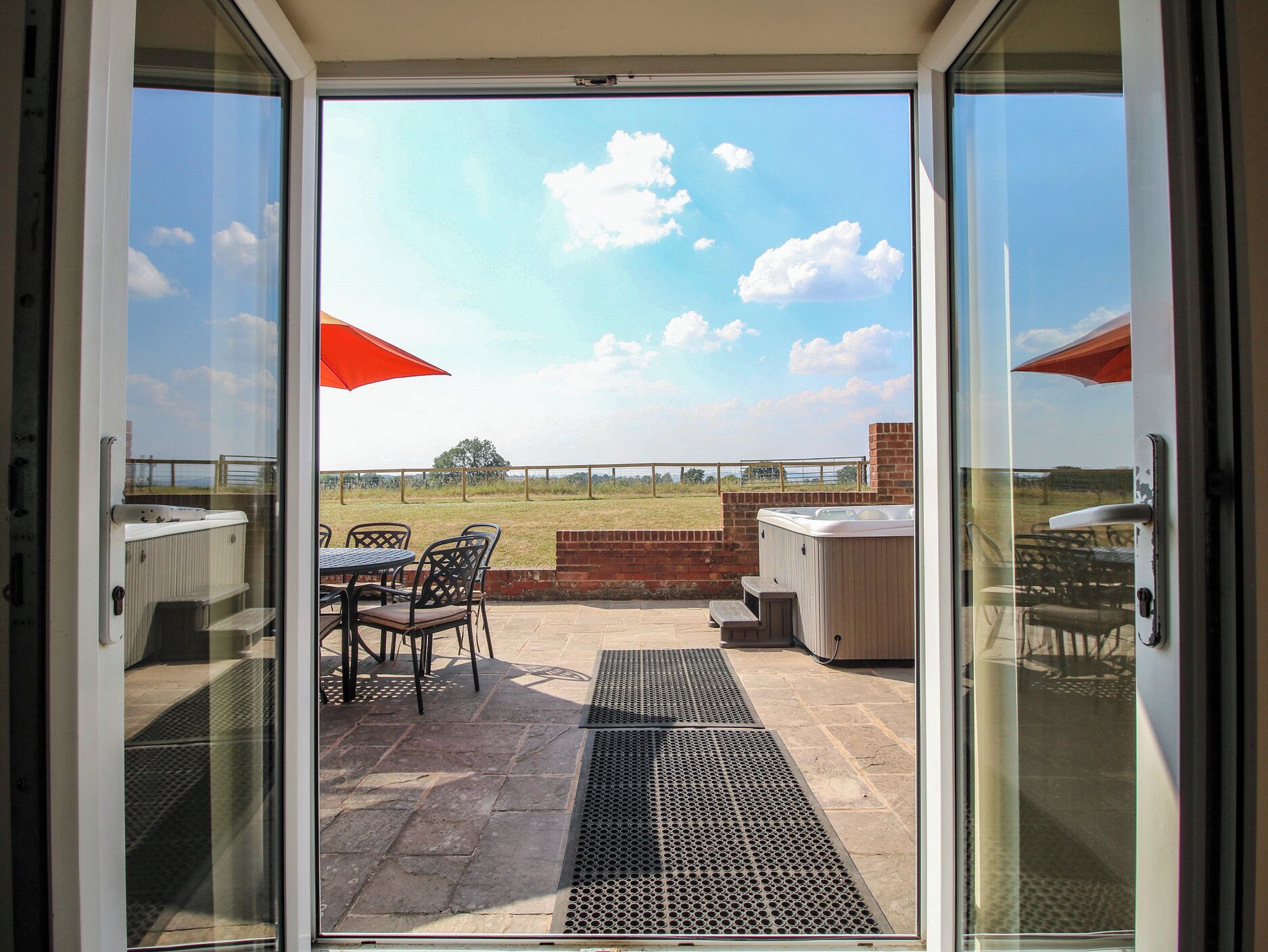 A patio area with outdoor seating and a hot tub.