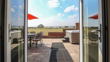 A patio area with outdoor seating and a hot tub.