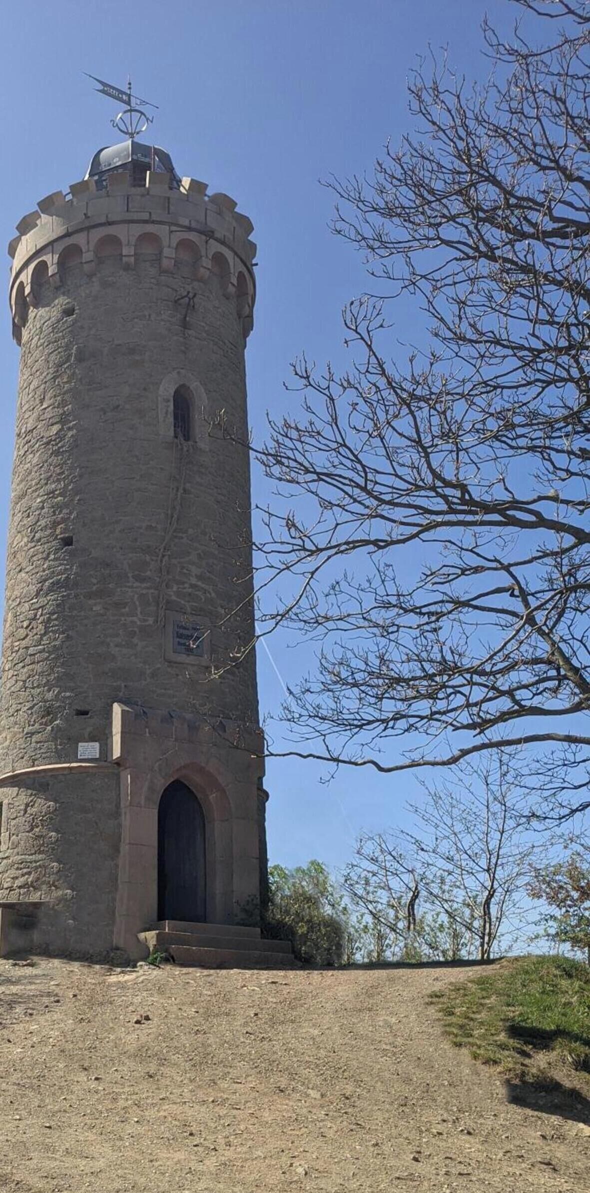 A stone tower with a rounded top and a single arched entrance.
