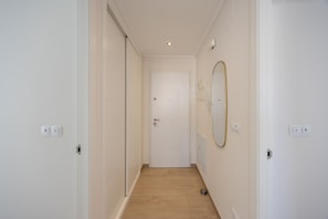 A narrow hallway with a wooden floor, white walls, and a door at the end. - Casa BiBo – Comfort & Relax on the Costa Blanca (Orihuela Costa)