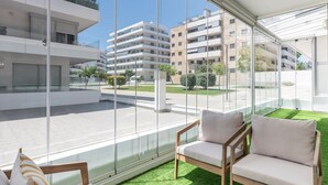 A modern apartment with a balcony, large windows, and a view of other buildings. - Exclusive apartment near Puerto Banús - 4 guests (Marbella)