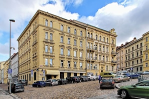 A multi-story building with a classic architectural style, featuring a series of windows and balconies. - Kora Premiere Collection (Hlavní město Praha)