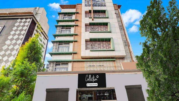 A multi-story building with a sign reading 'Collection'. - Classic With Balconyarjun International (Lucknow)