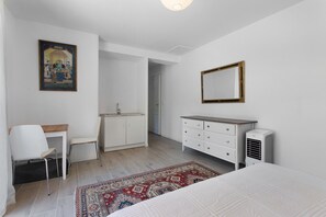 A bedroom with a bed, a bedside table, a chair, a dresser, a mirror, and a painting on the wall. - Villa 'Maison Mennoise' with Swimming Pool (Tourrettes)