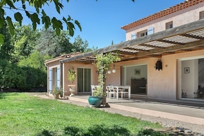 A two-story building with a patio, a dining area, and a covered outdoor space. - Villa 'Maison Mennoise' with Swimming Pool (Tourrettes)