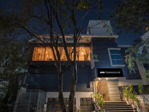 A modern two-story house with a visible staircase and a balcony. - Premiumsri Sai Suites (Bengaluru)