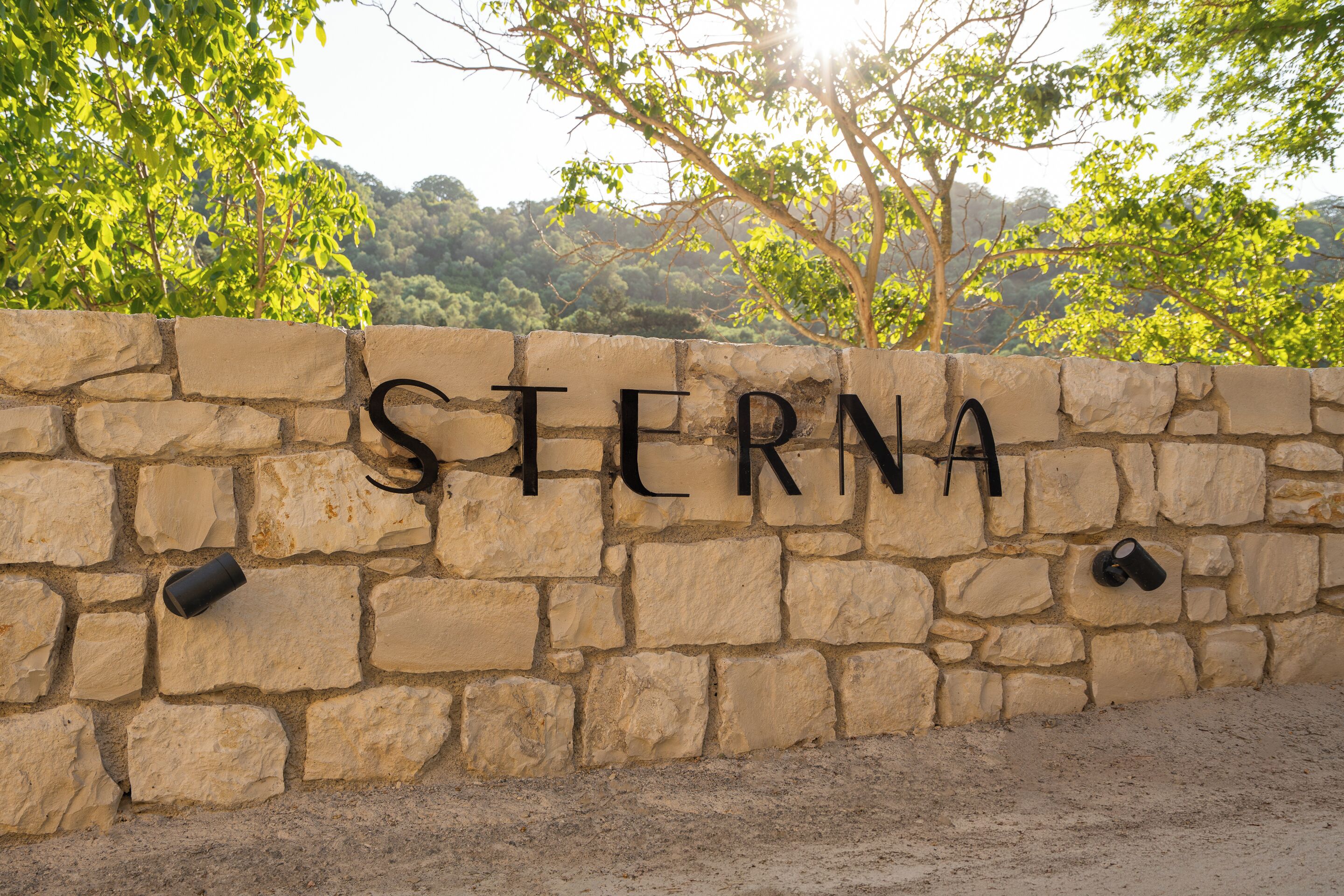 A stone wall with the word 'STERNA' carved into it.