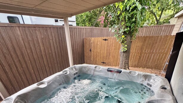 A hot tub with multiple jets, a control panel, and a wooden deck area. - Lake Texoma Haven-Luxury Getaway Near Lake Texoma w/ Hot Tub (Pottsboro)
