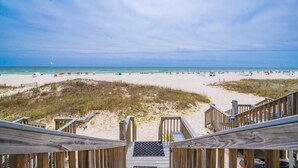A wooden staircase leading to a beach with a clear sky. - Cinco Brisas 2 3 Bedroom Home (Orange Beach)