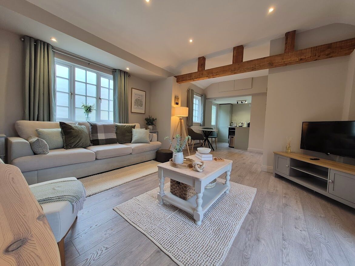 Enjoy a luxurious open-plan living area with a striking exposed beam