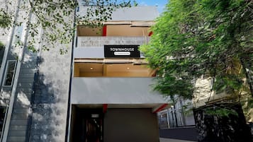 A modern building with a sign reading 'TOWNHOUSE & Company Serviced.'