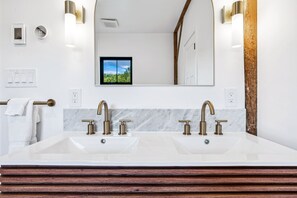 A bathroom with a large mirror, two sinks, and a towel rack. - Entire Farm! The Homestead & Barn at Winterfound (Woodstock)
