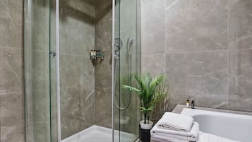 Comfort Suite | Bathroom | Hair dryer, slippers, towels, soap