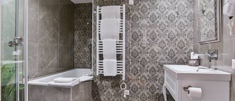 A bathroom with a shower, a bathtub, a towel rack, a sink, and a mirror.