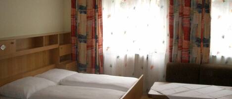 A room with a bed, a table, and a chair.
