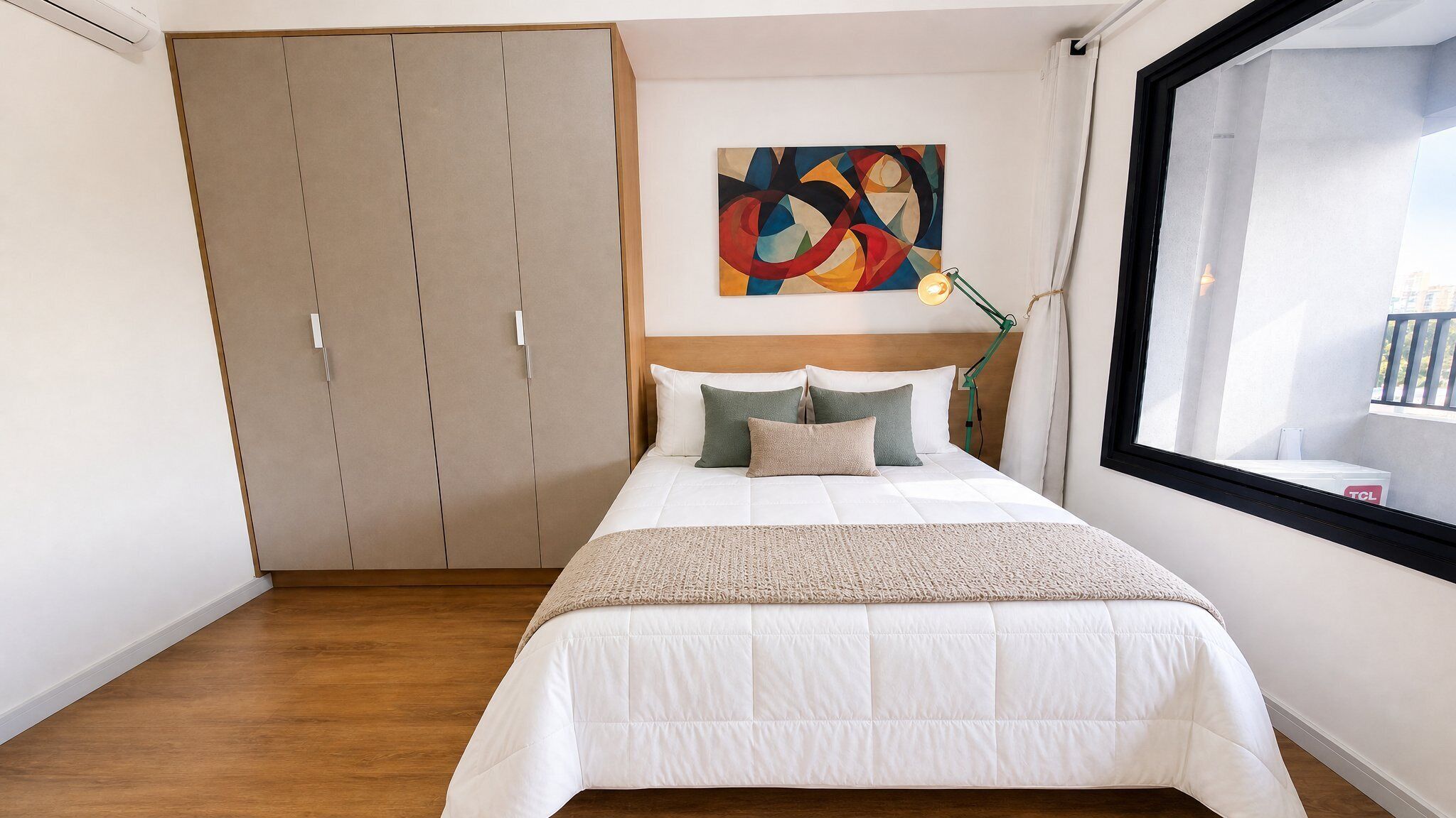 A bedroom with a bed, a painting, a window, and a wardrobe.