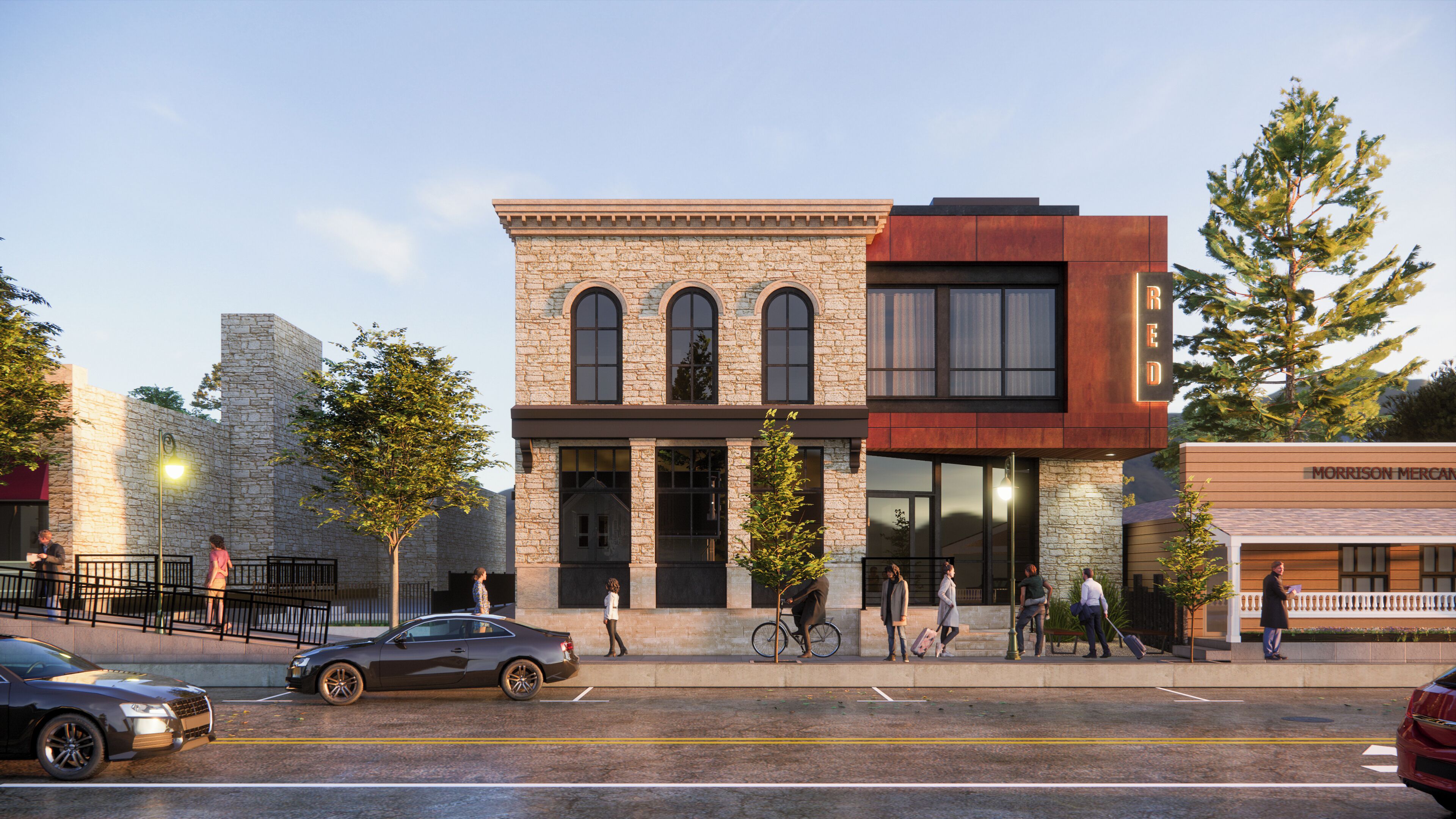 A building with a stone facade, large windows, and a modern addition with a glass front.