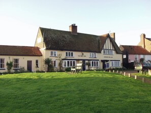A traditional building with a sign for 'The Bell Inn' and 'Adnams Fine Ales' on the side. - No 1 The Martins (Reydon)