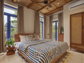 A bedroom with a bed, curtains, a ceiling fan, and a view through the window. - Staymaster Cove Villa - 3BR Private Pool (Parra)