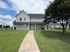 A two-story house with a front porch, a visible chimney, and a large tree to the right. - Picturesque Ranch House Retreat/Cattle Ranch/Twin Lakes/First Monday (Canton)