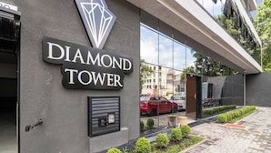 A building with a sign reading 'DIAMOND TOWER' and a modern architectural design.