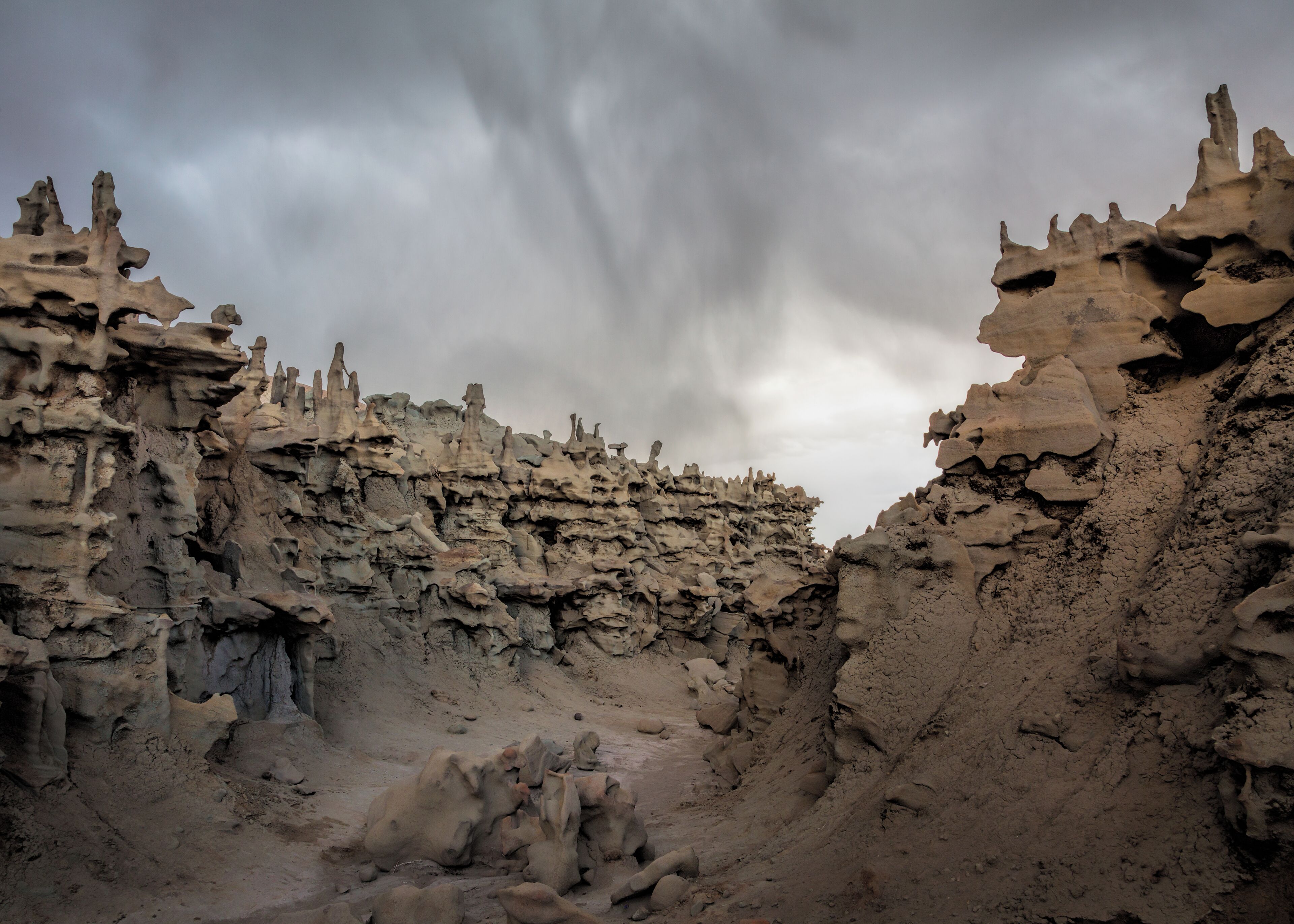 A rugged, rocky landscape with a narrow passageway between two cliffs.