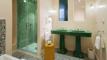 A bathroom with a shower, a sink, and a toilet.