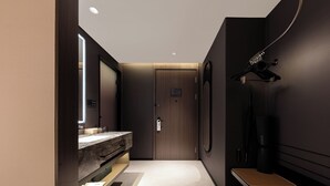 A modern bathroom with a vanity, mirror, towel rack, and a bench. - Atour Hotel Nanjing Jianye (Nanjing)