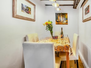 A dining area with a table set for two, framed artwork on the walls, and a vase with flowers on the table. - 2 Bed in Pickering (oc-y114) (Pickering)