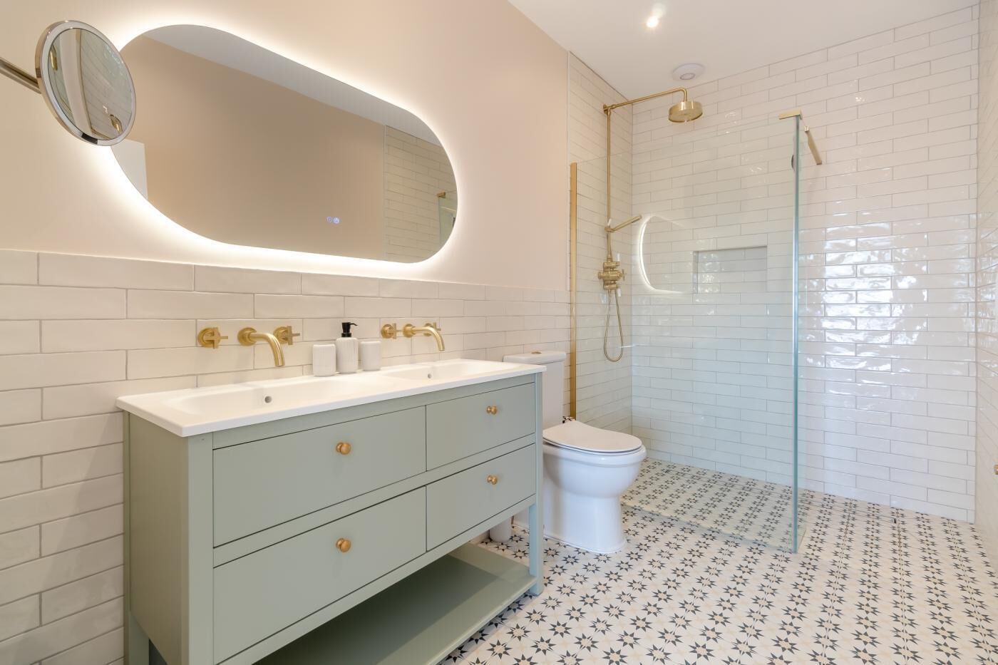 A modern bathroom with a vanity, a toilet, and a shower area.
