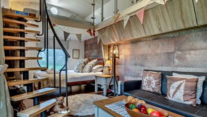 A modern interior with a staircase, a sofa set, a dining table with a fruit bowl, and a lamp. - 2 Bed in Ash (oc-o29006) (Stoke Fleming)