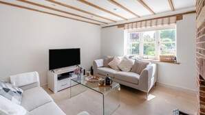 A living room with a television, sofa, and coffee table. - 3 Bed in Orford (oc-t32016) (Orford)