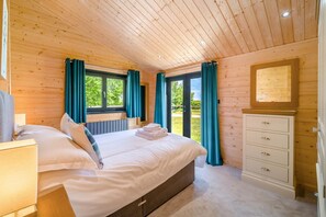 A bedroom with a bed, a dresser, and a window with curtains. - 2 Bed in Nafferton (oc-o31954) (Nafferton)