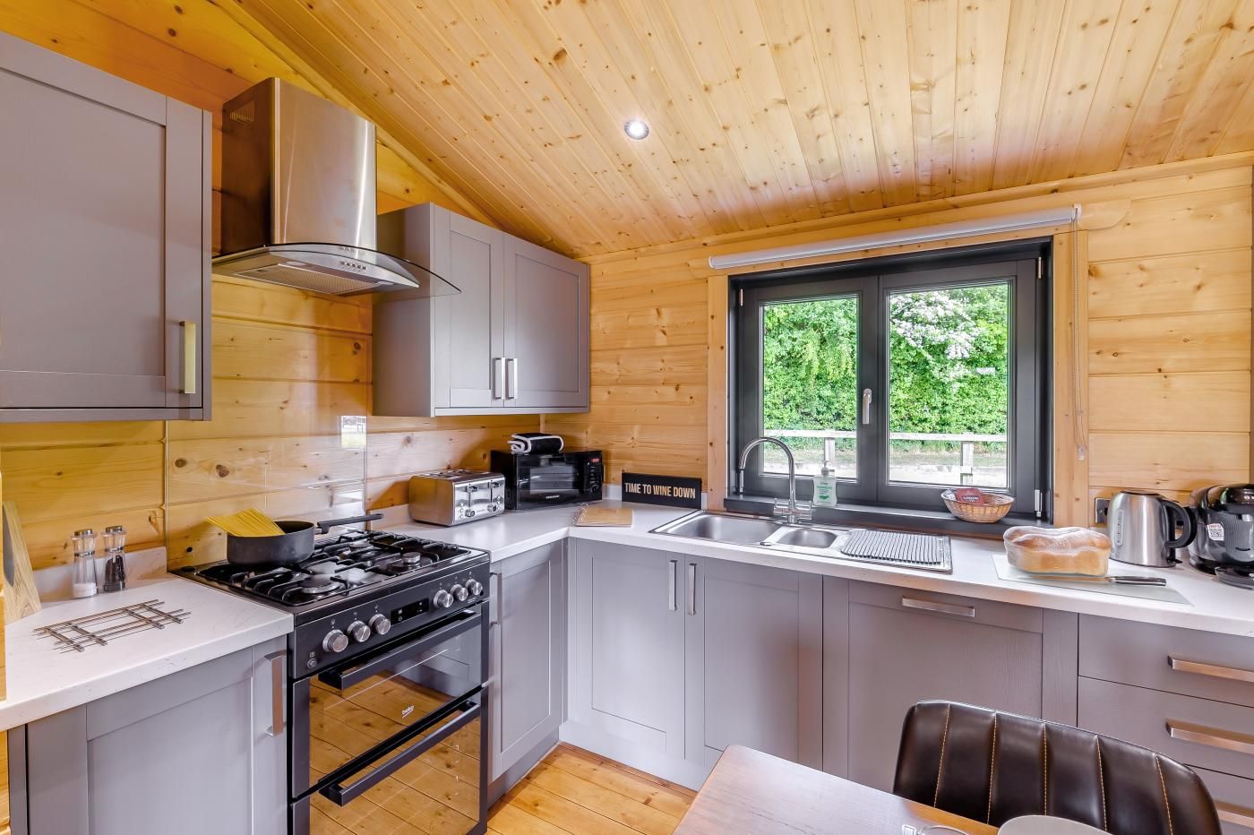 A compact kitchen with a gas stove, oven, and modern appliances.