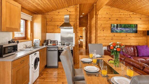A cabin interior with a kitchen, dining area, and living room. - 2 Bed in Llandinam (oc-t31972) (Llandinam)