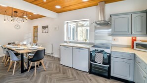 A modern kitchen with a wooden ceiling, grey cabinets, and a built-in oven. - 4 Bed in Bath (oc-bhr4) (Bath)
