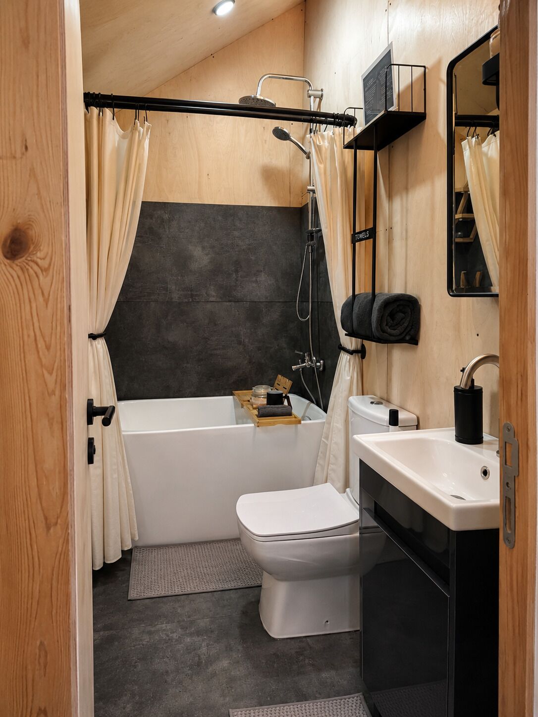 A compact bathroom with a bathtub, toilet, and sink.