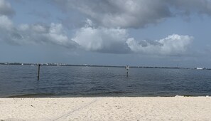 A beach with a clear sky and calm water. - Charming Pet-Friendly 4BR Cape Coral, minutes from Pine Island and Yacht Club! (Cape Coral)
