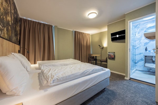 Wake up to soft daylight and a spa-like bathroom nearby.