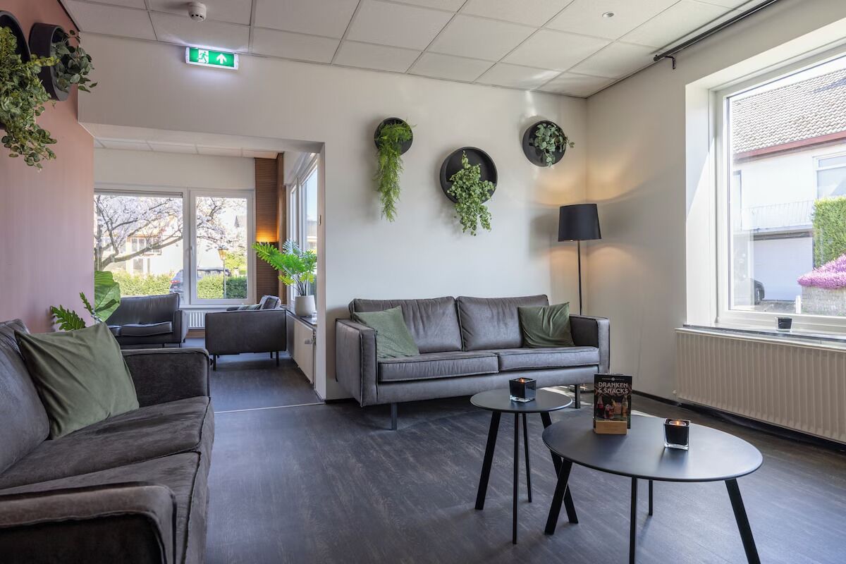 Relax with friends in the bright lounge with greenery accents.