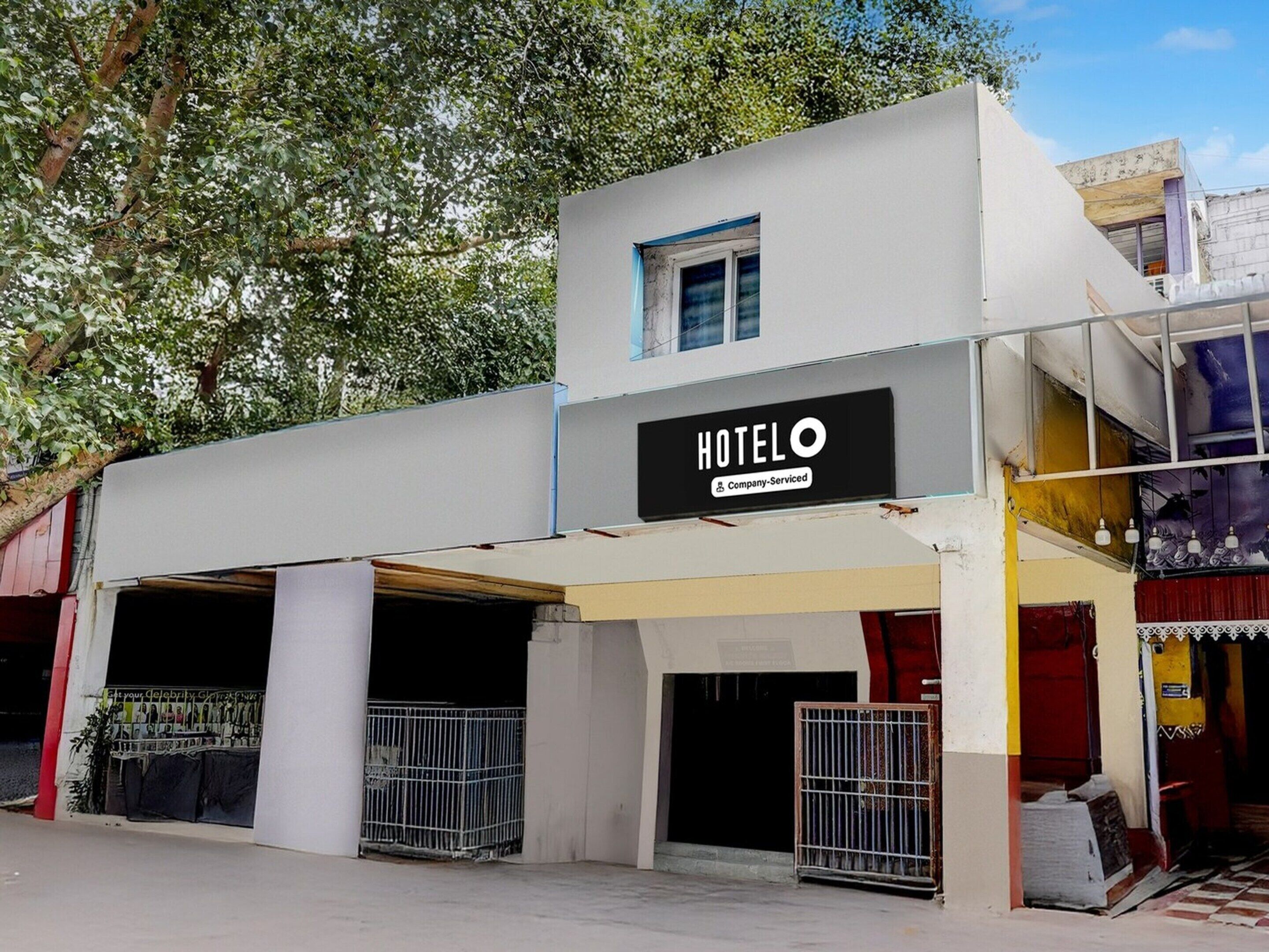 A building with a sign that reads 'HOTEL' and 'Company-Serviced.' There are two visible entrances with metal gates.